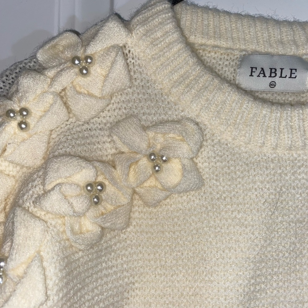 White sweater with floral detail